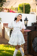 Model wearing the Camila Bella Dress in ivory with blush pink and blue paisley florals, flutter sleeves and a braided waist belt