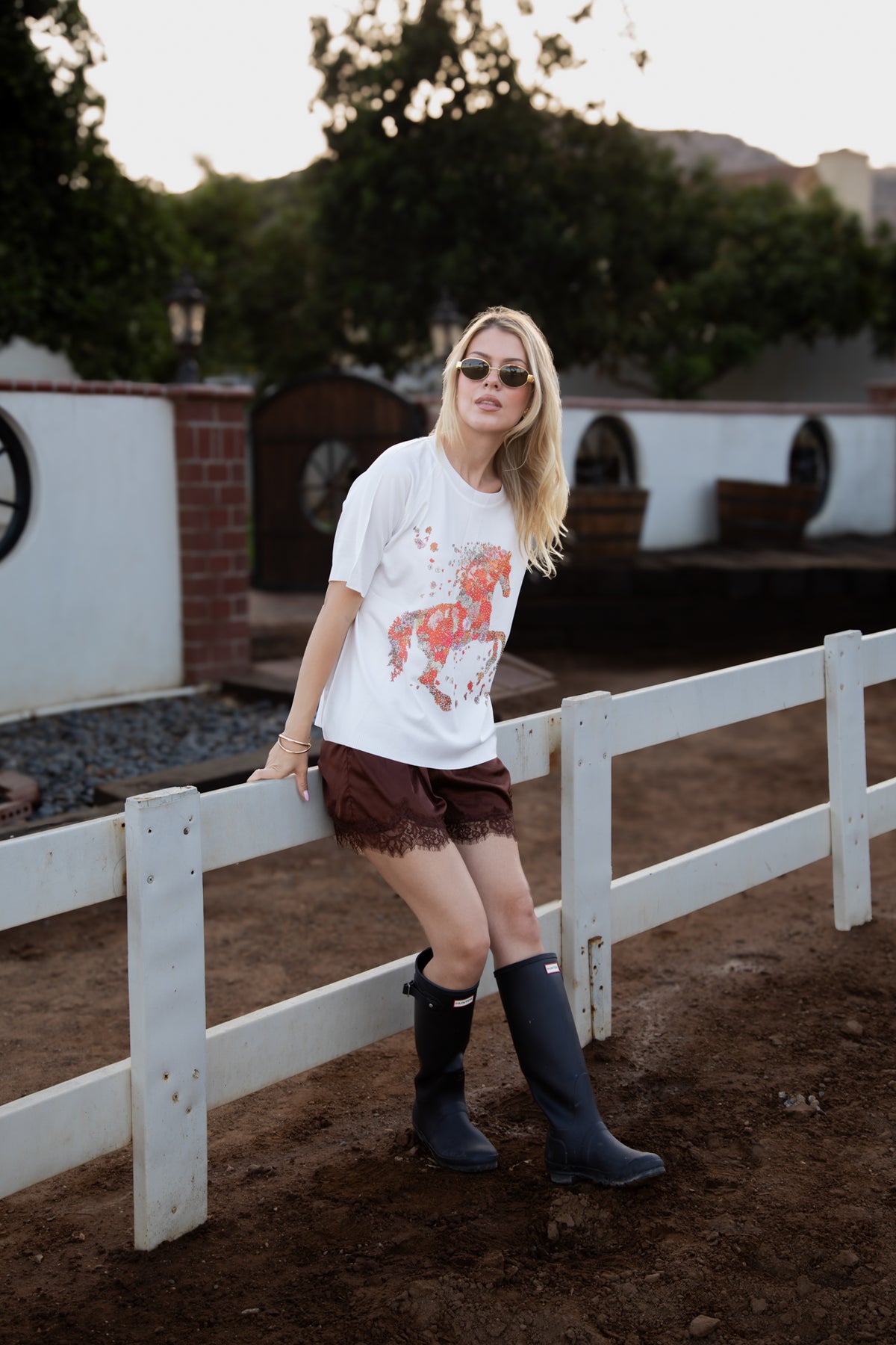 Model wearing the Andalucia ivory knit blouse with an embellished sequin horse design