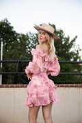 Model wearing the Ariel Pink Set, an off-the-shoulder ruffle top and tiered mini skirt in pink floral