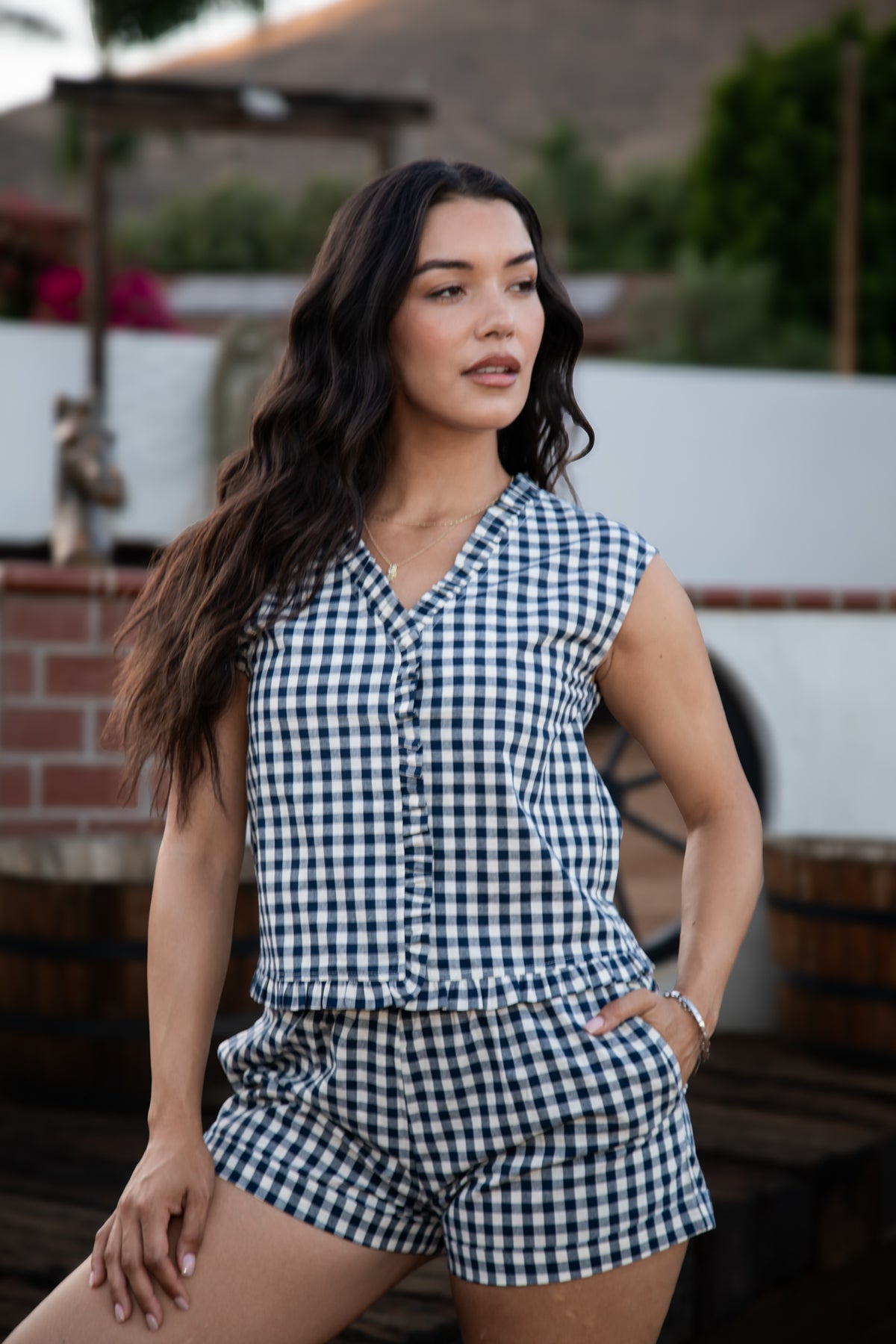 Model wearing the Sierra Gingham Two-Piece Set in navy and white with a ruffled hem top