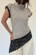 Model wearing the Arianna Lace Top, a mini check top with cowl neck and asymmetric black lace hem