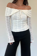 Model wearing the Athena Top in ivory floral lace with an off-the-shoulder neckline and front tie