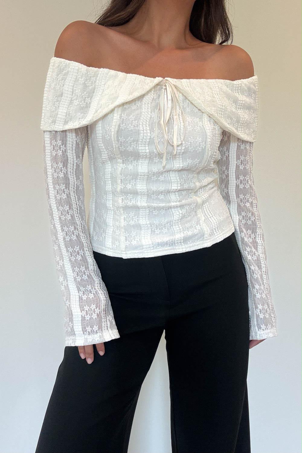 Model wearing the Athena Top in ivory floral lace with an off-the-shoulder neckline and front tie