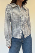 Model wearing the Alinna Top, a tailored navy and white check button-down with an oversized collar