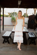 Model wearing the Isabella Dress, an elegant white dress with a timeless silhouette